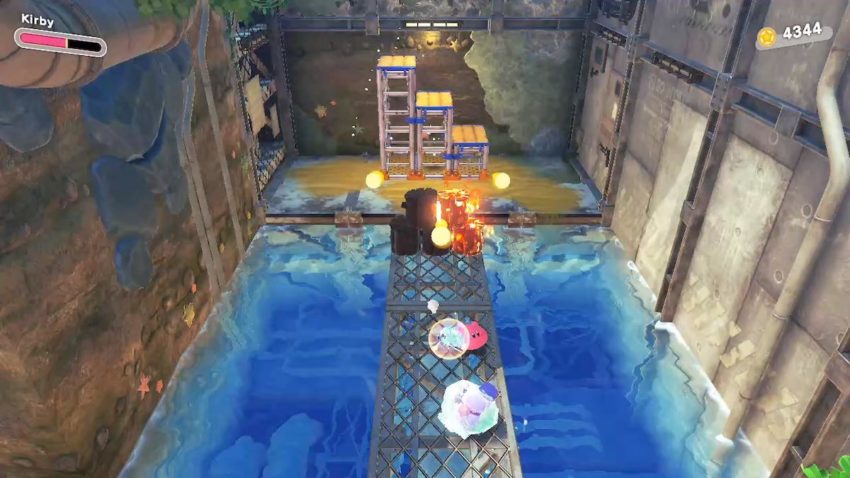 Kirby destroys some burning barrels using ice breath.