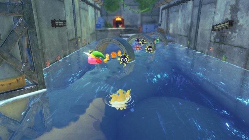 Kirby floats in water around spiked enemies