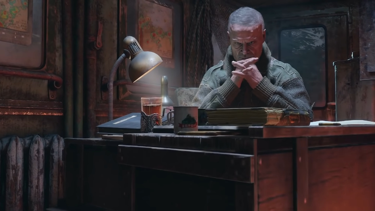 Miller sits at the table with his arms crossed in Metro Exodus.
