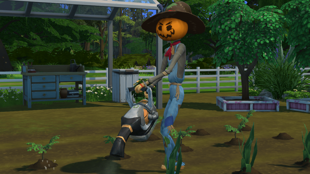 A Sim scarecrow with a pumpkin head and a large hat uses a leaf blower on some crops.