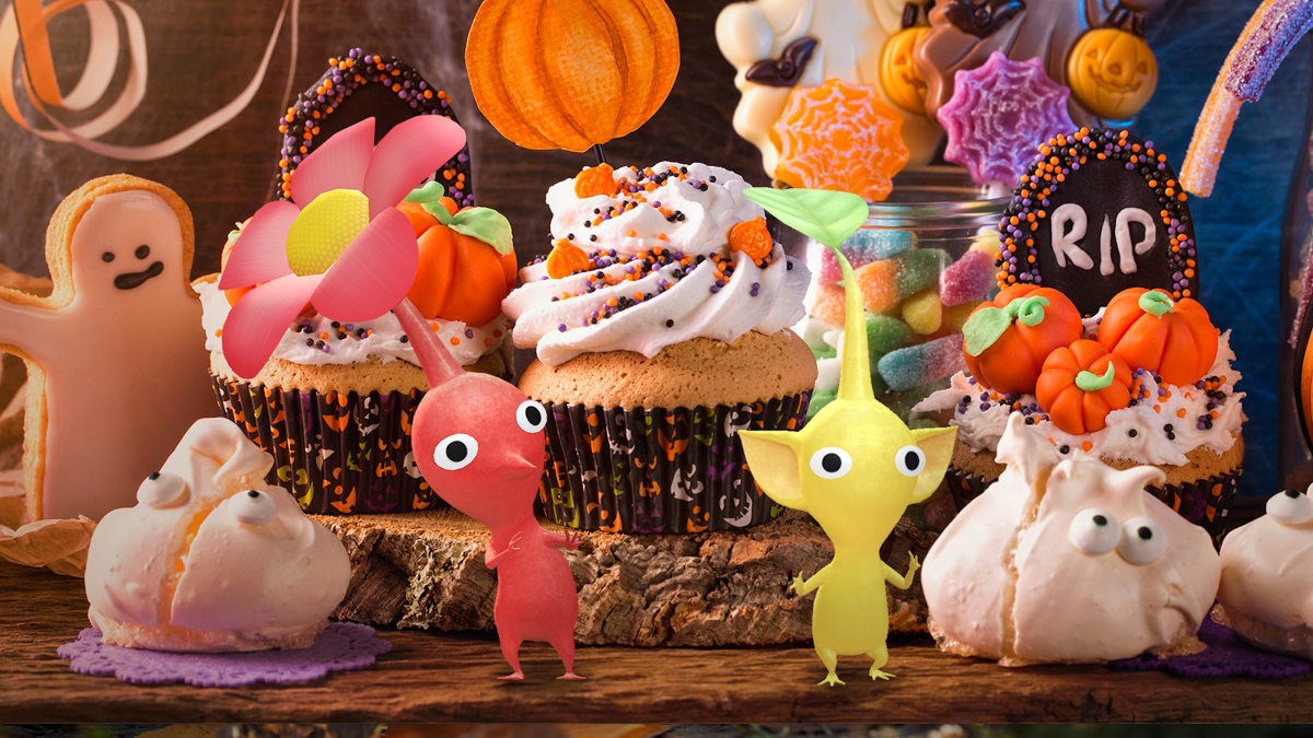 A red and a yellow Pikmin frolic in front of a display of Halloween themed treats
