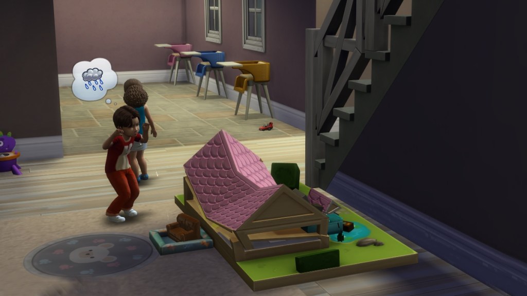 Two miserable Sims toddlers wail next to a broken doll house.