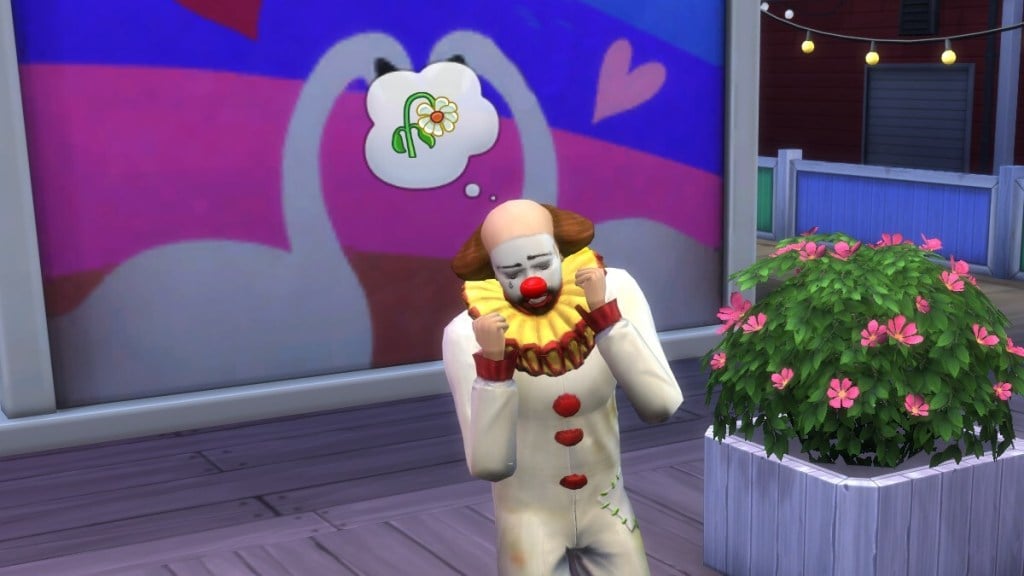 A tragic clown looks emotionally destroyed as he stands in front of a mural of two swans with their necks arched like a heart.