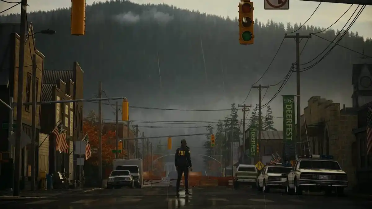 Saga Anderson standing in the middle of a deserted city street looking up at a forest on a mountain