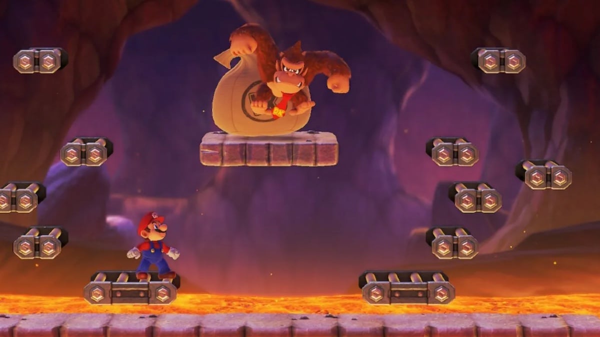 Mario looks up at a menacing Donkey Kong in a dark cave full of lava.