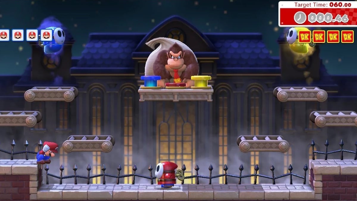 Mario hops down onto a lower platform, which resembles a city rooftop, and heads towards a clockwork Shy Guy. Above, two ghost Shy Guys float around. Donkey Kong waits with his sack of stolen goods. In the background, a night sky and a large building that looks like it could be the First National Bank of Gotham.