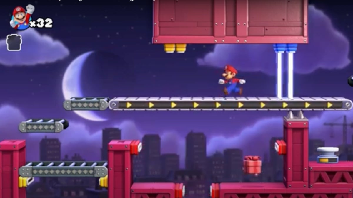 Mario runs against the current on a conveyor belt. The platforms resemble a construction site and appear to be made of metal beams. The background features a larger-than-life crescent moon against a purple night sky. Below, darkened skyscrapers rise up and a crane operates. 