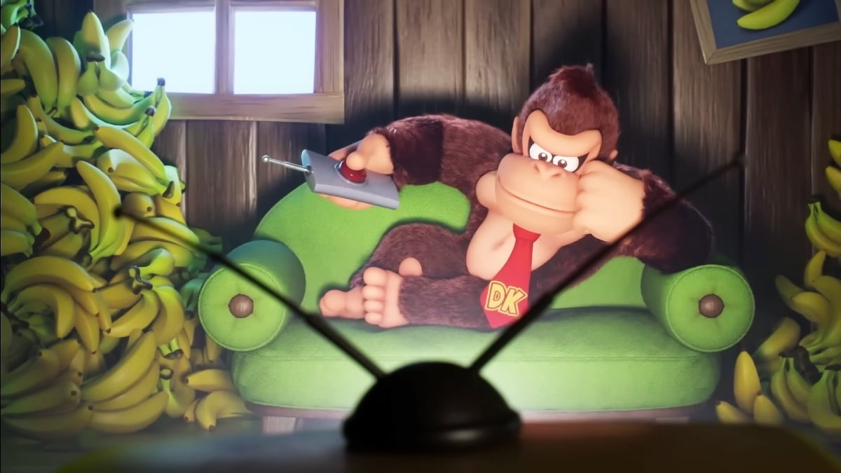 Donkey Kong sits and listlessly watches television. Next to him, sits a large pile of bananas, likely a TV-watching snack. He is very relatable.