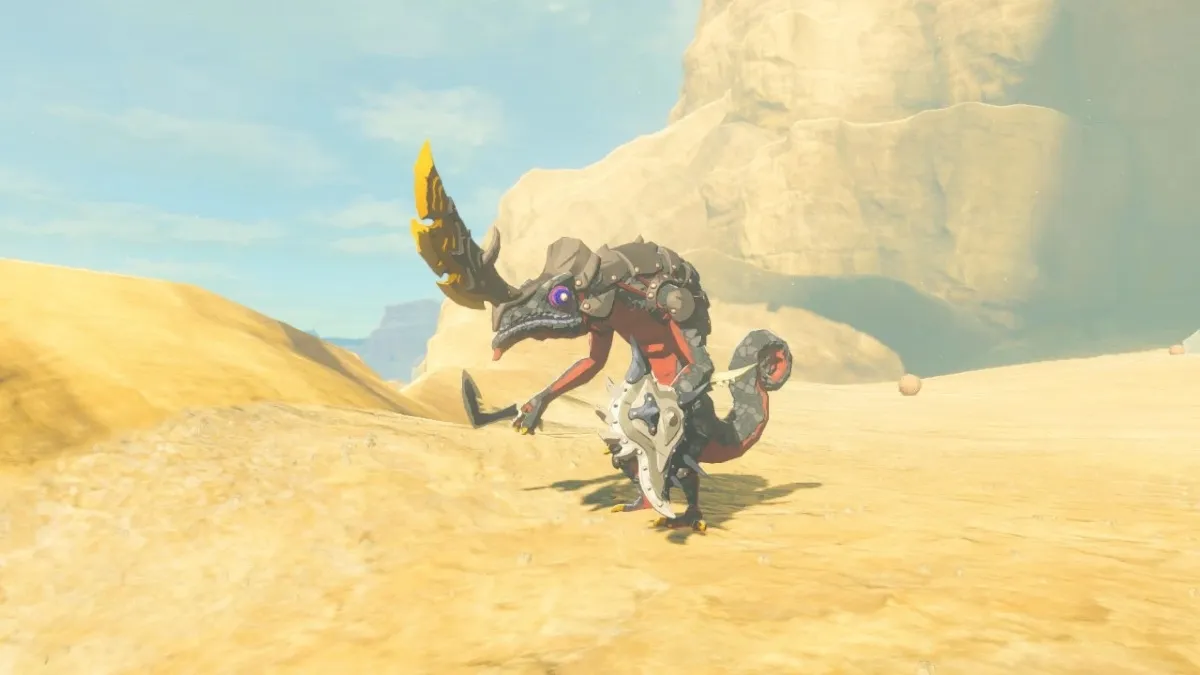 A black Lizalfo, a chameleon-looking creature that stands on two legs, stands in a desert landscape. It is heavily armed and also has a large, dangerous-looking, horn on its head.