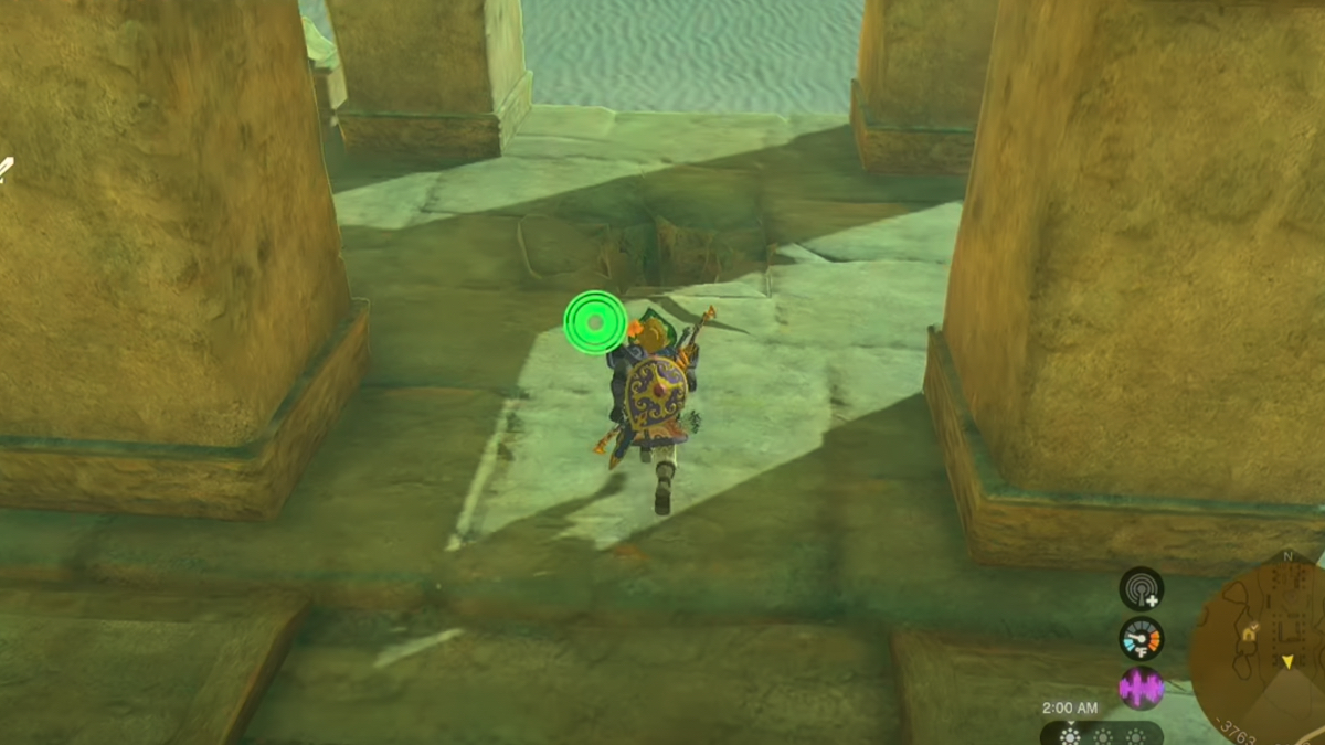 Link approaches a small hole in the ground of an ancient temple.