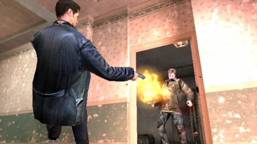 Max Payne shooting a guy through a doorway.