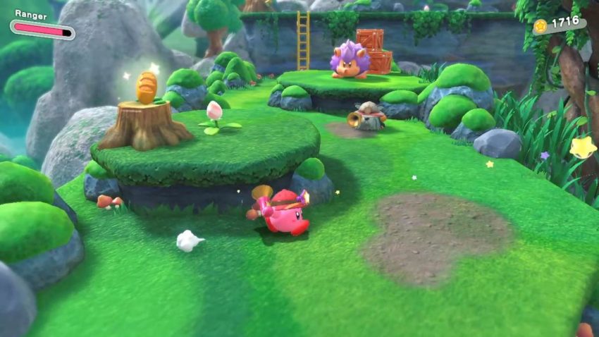 Kirby runs through a level as a baguette sits atop a tree stump