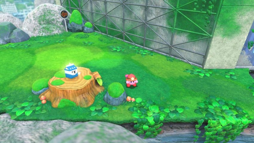 Kirby stands next to a tree stump that has a carton of milk on it