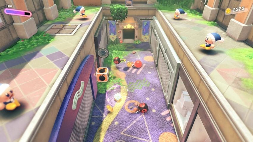 Kirby stands in a hallway surrounded by enemies