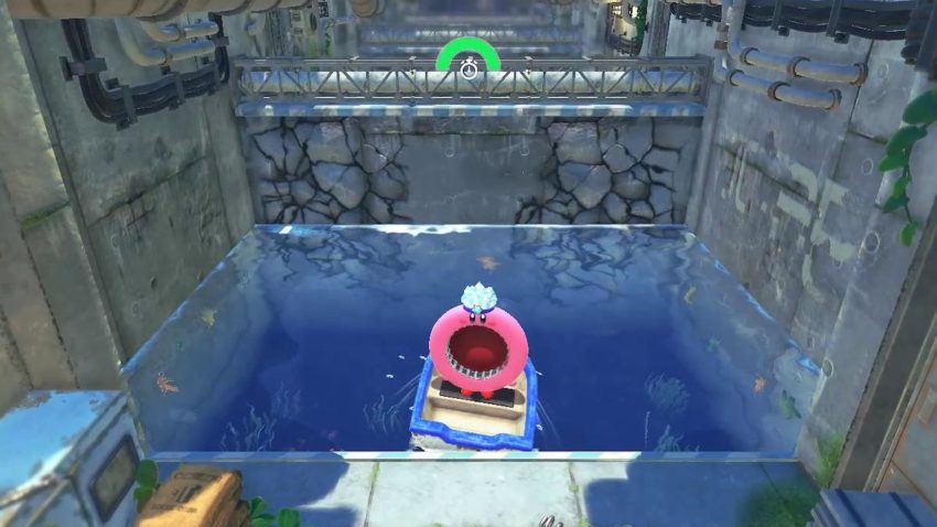 Kirby sits in a boat at the start of an obstacle course