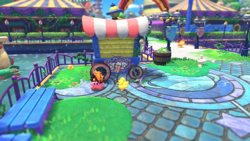 Kirby stands with a duckling by a popcorn cart