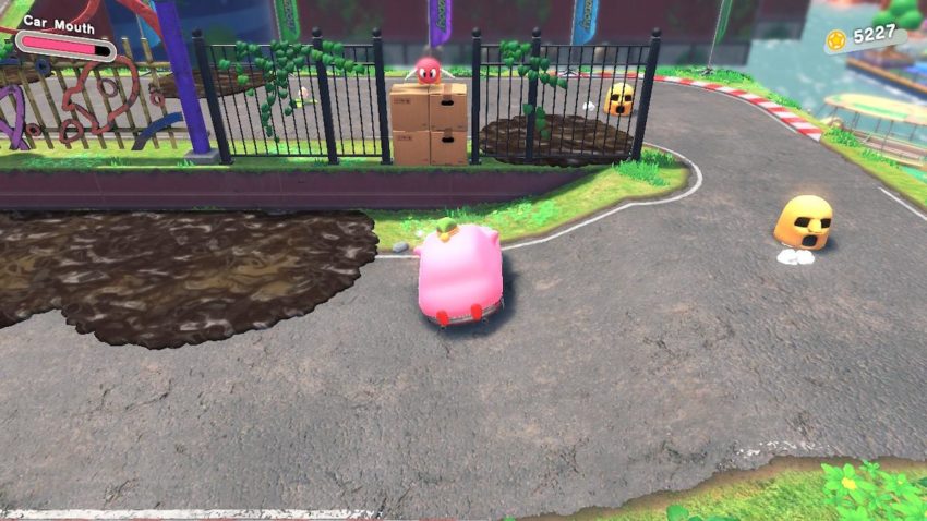 Car Kirby sits in front of breakable boxes filling a hole in a gate