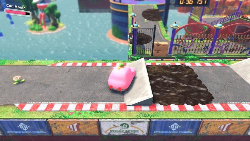 Kirby prepares to jump through some boxes filling a hole in a gate